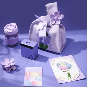 Floral knitted tote bag gift set with a 350ml cup, floral hair claw, and greeting cards.