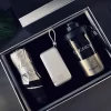 Premium Vacuum Cup Business Gift Set with Everyday Lifestyle Accessories Luxury corporate gift box set featuring a stylish vacuum tumbler with "CHERISH" branding, a compact metallic silver power bank with a lanyard, and a folded silver compact umbrella arranged neatly in a dark presentation box.